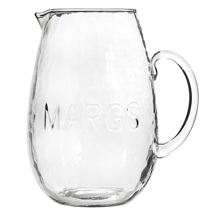 A clear glass pitcher with a hammered finish and the word 'MARGS' embossed on the side.