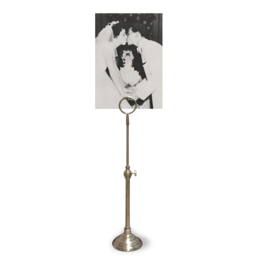 A telescoping picture stand with a vintage metal finish, displaying a black and white picture.