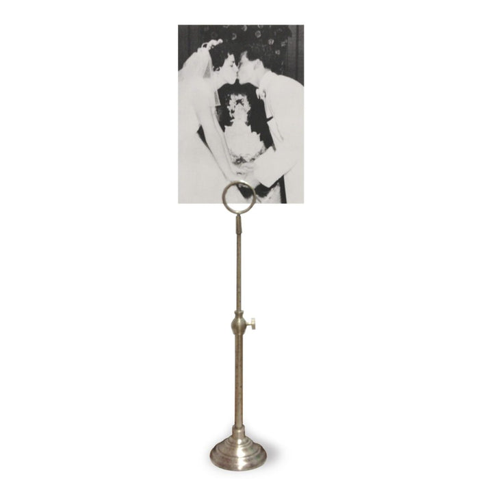 A telescoping picture stand with a vintage metal finish, displaying a black and white picture.