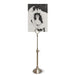 A telescoping picture stand with a vintage metal finish, displaying a black and white picture.