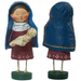 Figurine of a woman holding a baby, with a blue hood and red dress, on a white background.