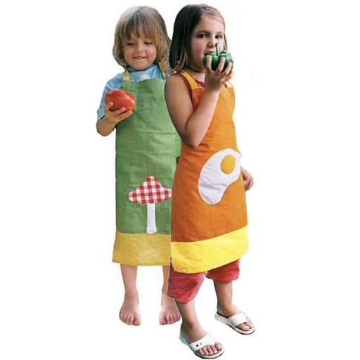 Two children wearing colorful aprons holding fruits and vegetables on a white background