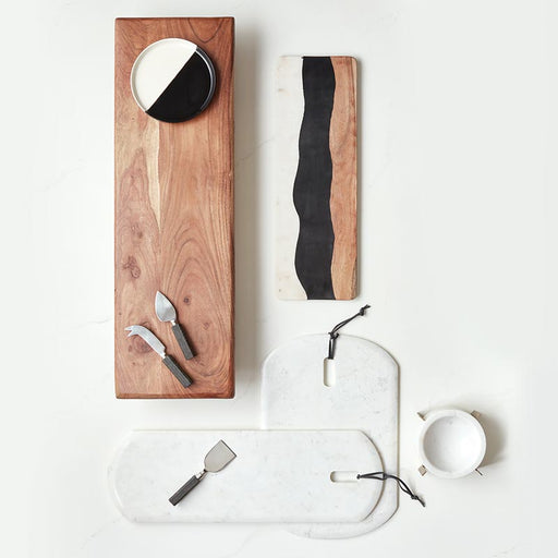 Black and white dipped ceramic plate with a minimalist design, featuring a clean contrast between the two colors.