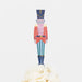 Colorful toy soldier cupcake topper on a white background