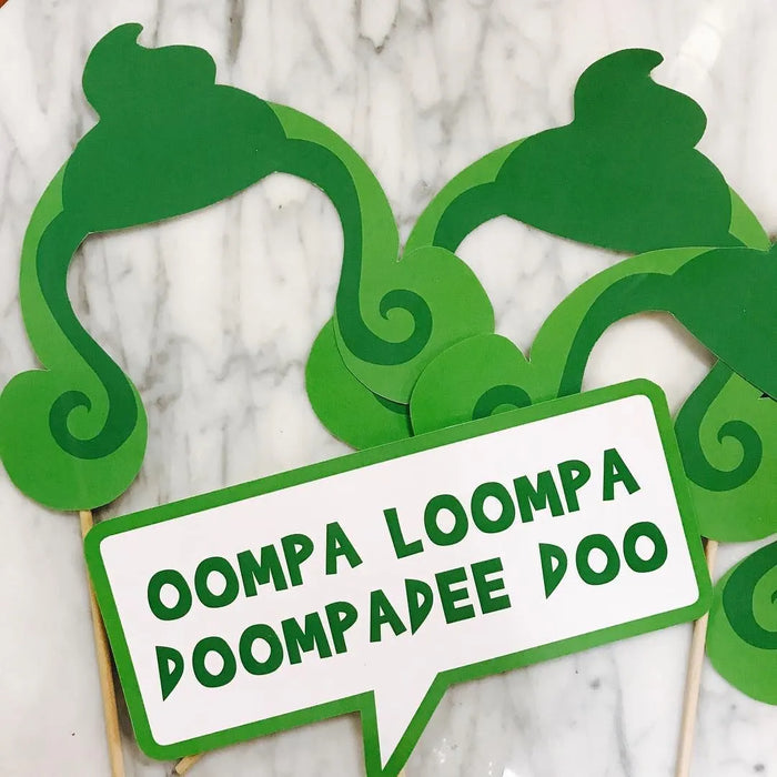 Green Oompa Loompa hair and "Oompa Loompa Doompadee Doo" speech bubble photo booth props on wooden dowels — perfect for Willy Wonka and Charlie and the Chocolate Factory themed parties