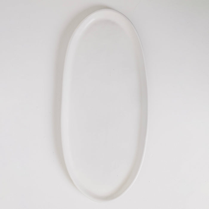 White oval plate on a light gray background