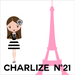 Illustration of a woman in a black and white outfit with a pink Eiffel Tower and 'Charlize N!' text.