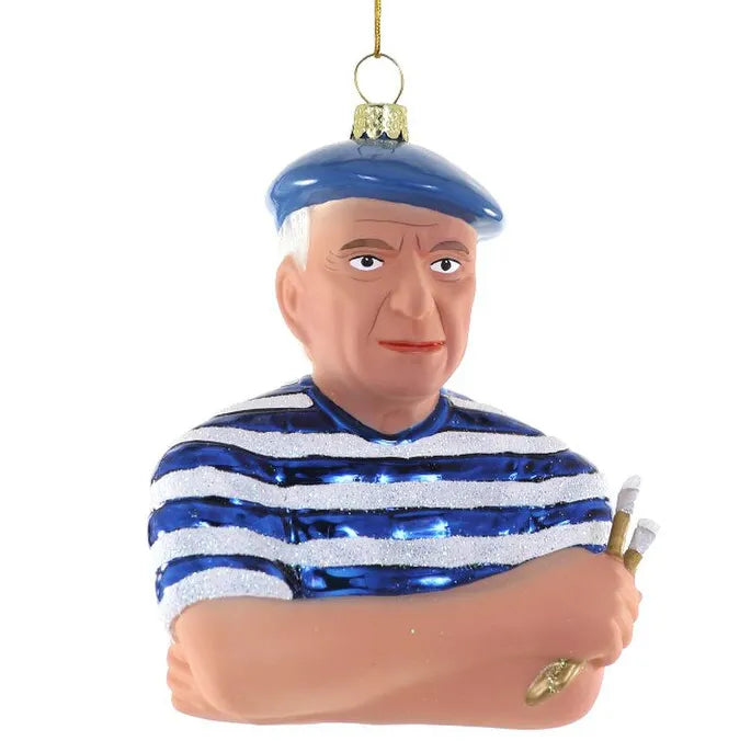 Glass ornament of Pablo Picasso in a blue and white striped shirt with a blue cap, holding a paint brushes. Mouth-blown Pablo Picasso glass ornament wearing striped shirt and blue beret, hand-painted with blue and silver shine — art-inspired Christmas decor