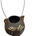 A black cat paper mâché bucket with blue eyes, cream whisker details, and orange inner ears,.