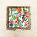 Decorative wall art with parrots and tropical leaves in a woven frame.