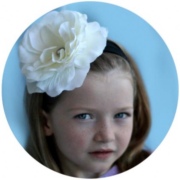 Girl wearing peony flower headbands in white – kids hair accessory from Modern Lola