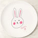 White kids melamine plate with a hand-drawn rabbit face and the name 'Susie' on a light wooden surface.