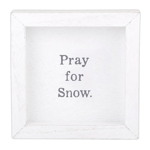 White framed sign with 'Pray for Snow' text on a white background