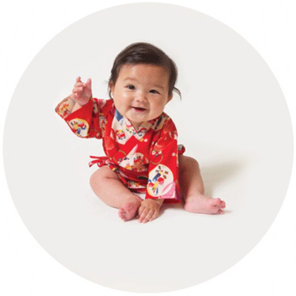 Colorful Sweet Treats kimono-style baby onesie in woven cotton with side ties and playful dessert and animal print