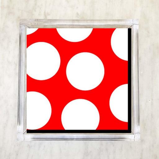 A packet of red luncheon napkins with large white polka dots is displayed against a white background.