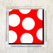 A packet of red luncheon napkins with large white polka dots is displayed against a white background.