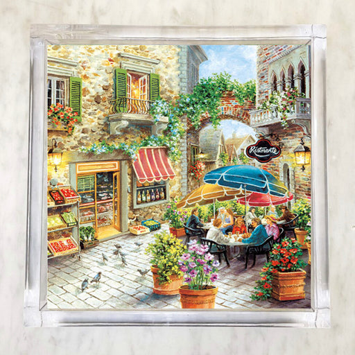 Illustrated paper napkin of an Italian ristorante scene with outdoor dining, cobblestone streets, flower pots, colorful umbrellas, and stone buildings with green shutters.