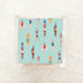 Riviera Swimmers cocktail napkins in acrylic holder, colorful illustrated swimmers on teal background