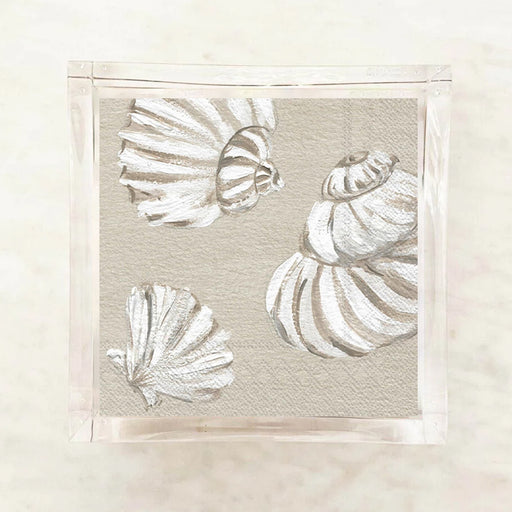 White shells cocktail napkins on a beige background