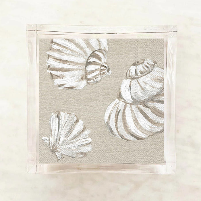 White shells cocktail napkins on a beige background