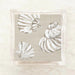 White shells cocktail napkins on a beige background