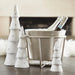 silver champagne bucket holding bottles on ice