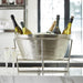 Silver aluminum champagne and wine tub on stand with bottles chilling on ice