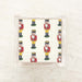 Packaged cocktail paper napkins with a printed pattern of nutcrackers.