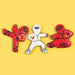 Three cookie cutters shaped like Ninjabread Men on a yellow background
