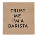 Napkin with 'Trust Me I'm a Barista' text on a brown background