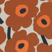 Pattern of brown flowers with orange centers on a beige background