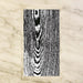 woodgrain guest paper towels with natural variegated wood pattern displayed in a clear holder, neutral napkins for entertaining