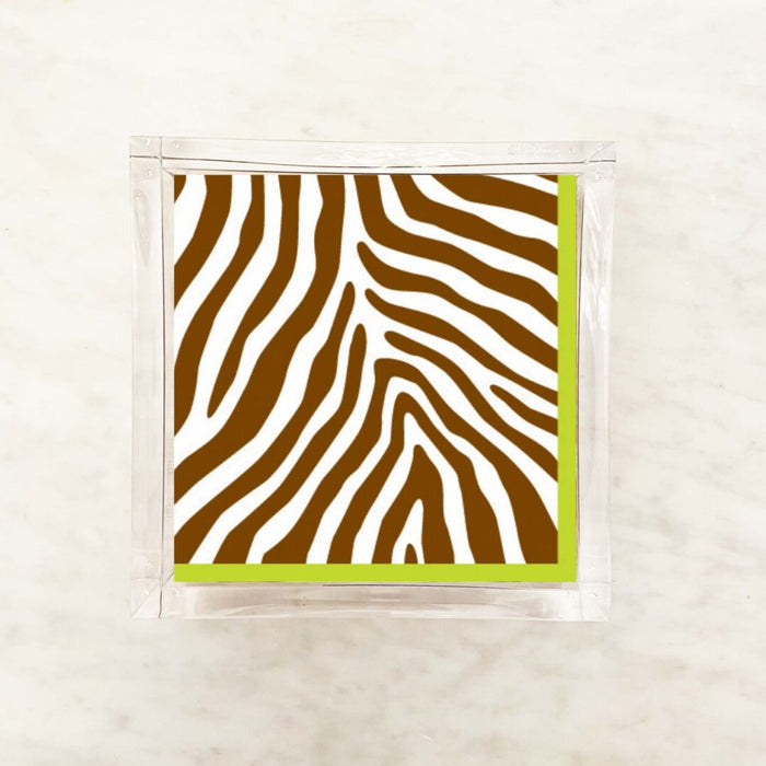 Paper napkin featuring a bold cocoa brown and white zebra stripe pattern with a green border
