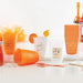 Aperol Spritz plastic cups — orange reusable cups with Aperol Spritz gold text, styled with cocktails