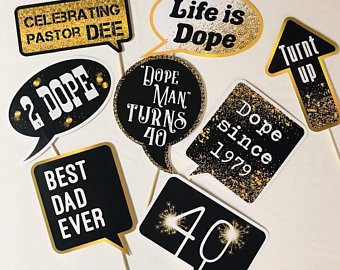 Set of 8 custom black and gold birthday photo booth props with personalized speech bubbles displayed together