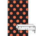 A plastic table cover with a pattern of large orange polka dots on a black background, displayed vertically with a small section unfolded to show the solid white underside.