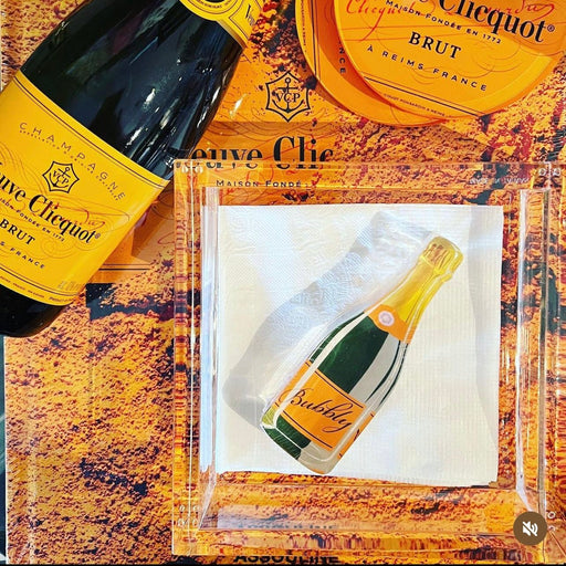 Champagne bottle and packaging on a textured surface