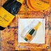 Champagne bottle and packaging on a textured surface