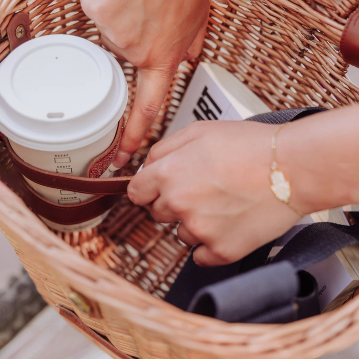 Interior of Cambridge wicker bicycle basket with coffee cup in drink holder strap