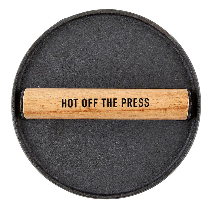 Cast Iron Meat Press for Smash Burgers — round cast iron press with Hot Off The Press engraved wood handle, top-down view