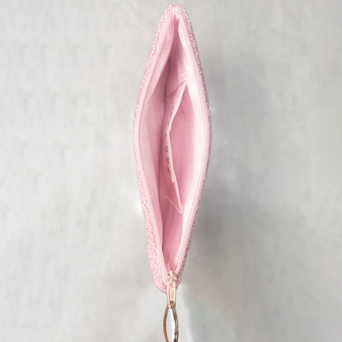 Inside view of pink beaded zipper pouch showing interior pocket and pink fabric lining