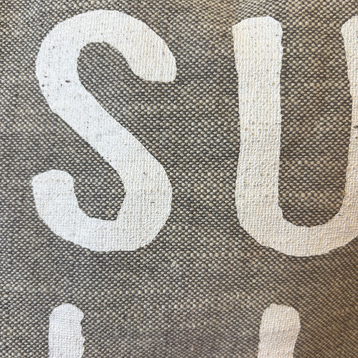 Close-up of fabric with 'SUMMER' text on a textured background
