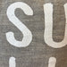 Close-up of fabric with 'SUMMER' text on a textured background