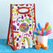 Dylan's Candy Bar insulated lunch tote with colorful candy print, shown with rock candy and gummy candy