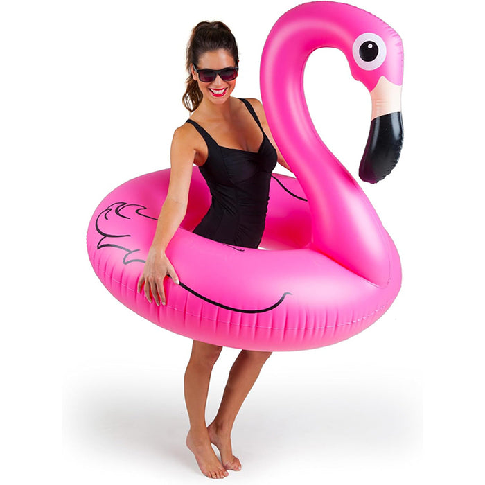 Woman holding a pink inflatable flamingo pool float on a white background