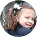 Girl wearing white bow ponytail bands in pigtails – handmade girls hair accessory from Modern Lola