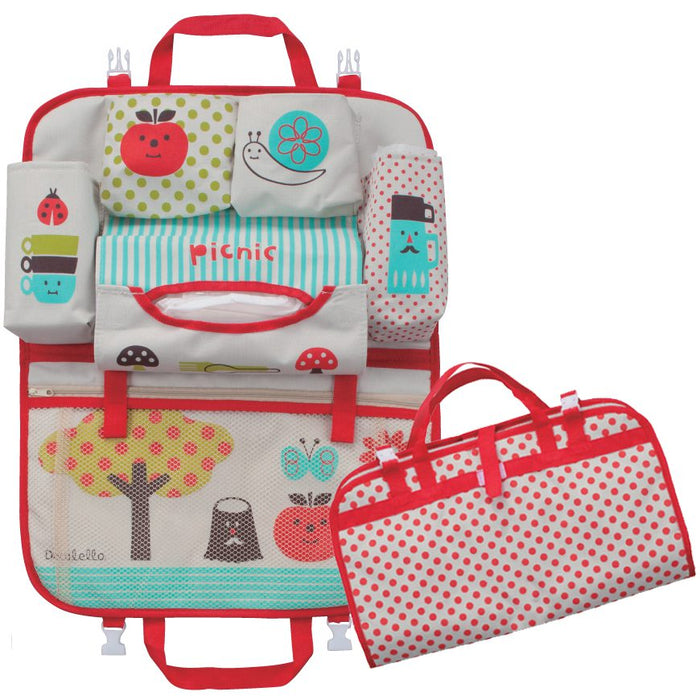 Red polka dot backseat car organizer installed in a car seat, holding a water bottle, snacks, wipes, and baby essentials in multiple pockets
