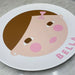 kids personalized melamine plate with a stylized face design and 'Eloise' text on a table setting.'BELLA' 