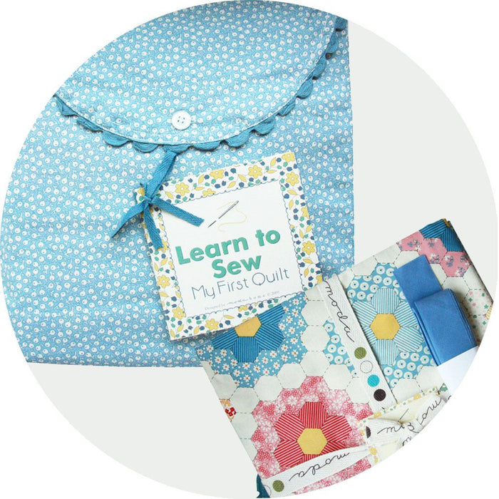 Learn to Sew My First Quilt kit with blue fabric pouch, quilt pieces, and sewing materials