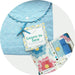Learn to Sew My First Quilt kit with blue fabric pouch, quilt pieces, and sewing materials
